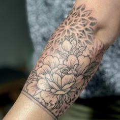 a person with a flower tattoo on their arm