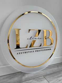 a white and gold sign with the letters lzb on it