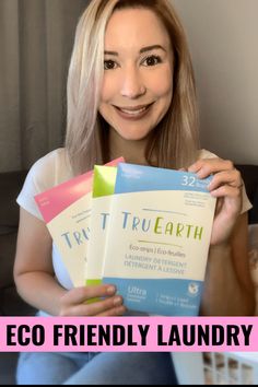 a woman sitting on a couch holding three books in front of her face with the words eco friendly laundry