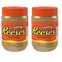 two jars of peanut butter sitting next to each other