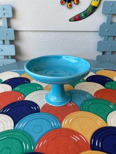 a blue bowl sitting on top of a colorful table