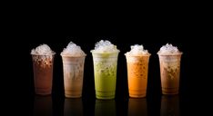 five different types of drinks in plastic cups