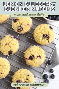 lemon blueberry muffins on a cooling rack with fresh blueberries in the background