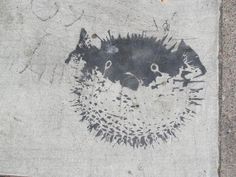 a drawing of a cat on the side of a building