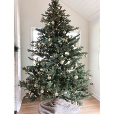 a small christmas tree in a room with white walls