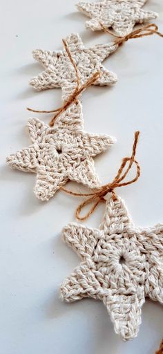 crocheted star ornaments with twine on white surface