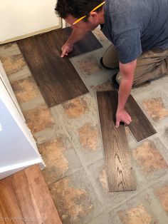 a man installing vinyl planks on the floor