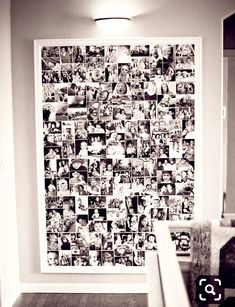 a wall covered in photos and pictures next to a stair case