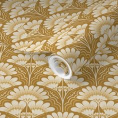 a gold and white wallpaper with flowers on it