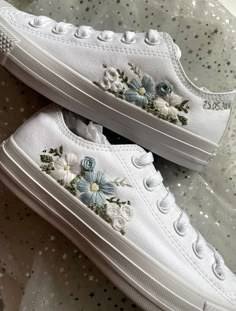 pair of white sneakers with flowers on them