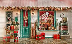 there is a christmas display in front of a store window with presents on the windowsill