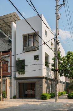 an apartment building on the corner of a street with power lines in front of it