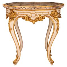 an ornately decorated table with marble top