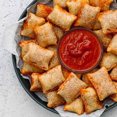 a platter filled with pastries covered in ketchup and breaded croutons