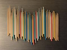 several different colored toothbrushes lined up on a wall