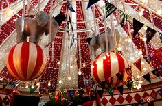 christmas decorations are hanging from the ceiling in an indoor area with lights and ornaments on it