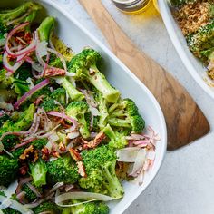 broccoli and onions in a white dish next to a wooden cutting board with a glass of beer