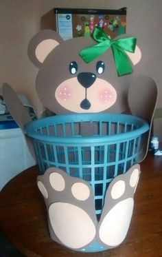 a teddy bear sitting in a basket on top of a table