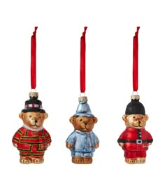 three ornaments in the shape of teddy bears hanging from red ribbon on each ornament