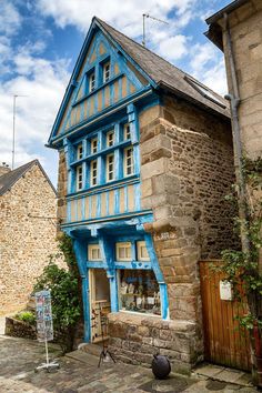 an old building with blue paint on it