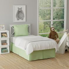 a child's bedroom with green and white bedding, teddy bear and teepee tent