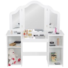 a white dressing table with mirror and shelves on the sides, including a teddy bear