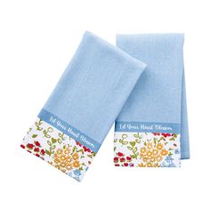 two blue towels with flowers on them and the words, all you need is linens