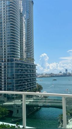 a balcony overlooking the water and skyscrapers