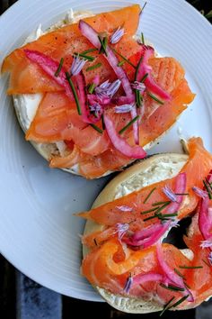 two bagels with smoked salmon and onions on them