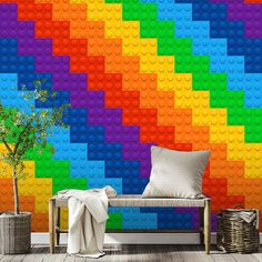 a room with a rainbow colored brick wallpaper and a white couch in front of it