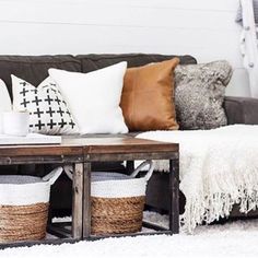 a living room filled with lots of pillows and blankets on top of a wooden table