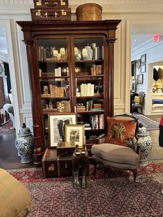 a living room filled with lots of furniture and bookshelves next to each other