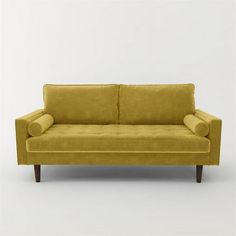 a yellow couch sitting on top of a white floor