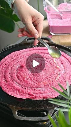 a person is cooking food in a pan on the stove top with a spatula