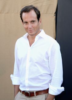 a man in white shirt and tan pants