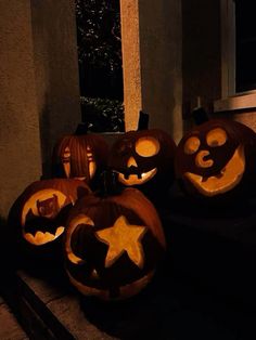 four carved pumpkins with faces and stars on them