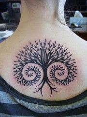 a woman with a tree tattoo on her back