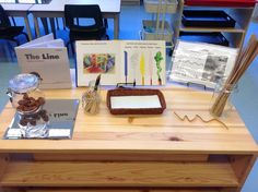 a wooden table topped with books and other items