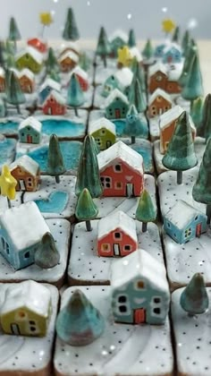 small ceramic houses and trees are on display