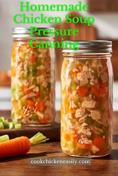 two jars filled with chicken soup sitting on top of a wooden table next to carrots and celery