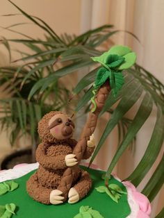 there is a cake decorated like a slotty holding a palm tree