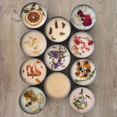 several bowls filled with different types of flowers and herbs