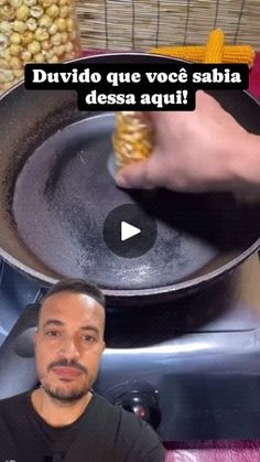 a man cooking corn in a frying pan on top of an electric burner