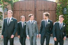 a group of men in suits standing next to each other