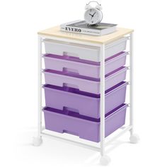 a white and purple storage cart with five bins on it, next to a clock