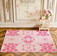 a pink area rug in front of a chandelier with flowers on the wall