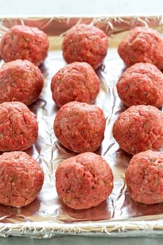 raw meatballs on a baking sheet ready to be cooked in the oven for dinner