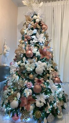 a decorated christmas tree with pink and white ornaments