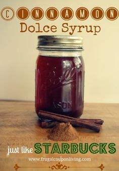 a mason jar filled with cinnamon dolce syrup sitting on top of a wooden table