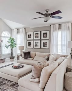 a living room filled with furniture and pictures on the wall next to a fire place